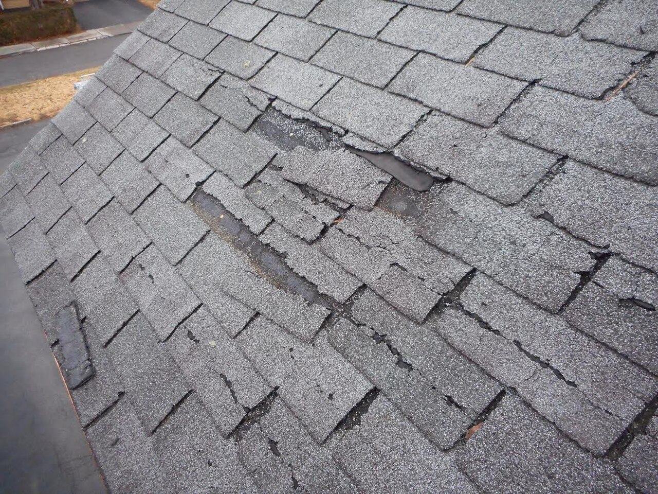 Asphalt shingle tabs missing, underlayment showing